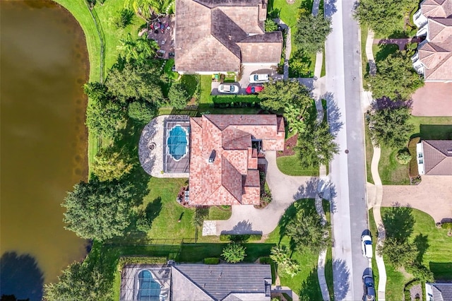 birds eye view of property with a water view