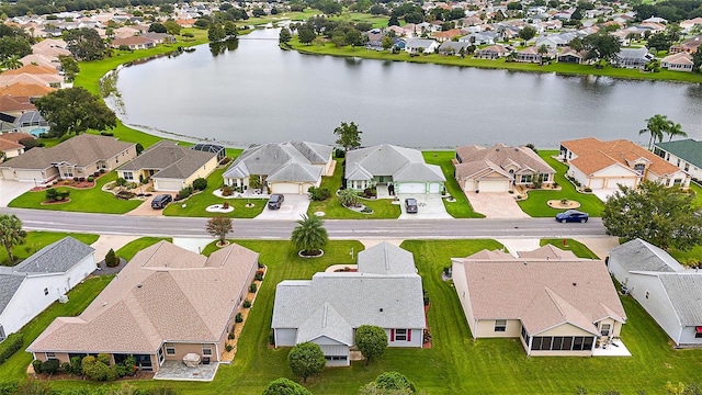 drone / aerial view with a residential view and a water view