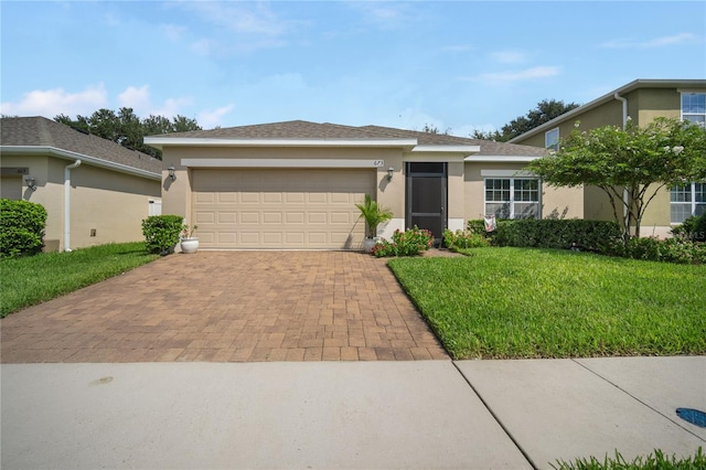 view of front of home featuring a garage and a front lawn