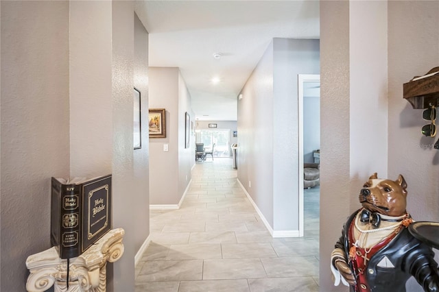 hall featuring light tile patterned floors