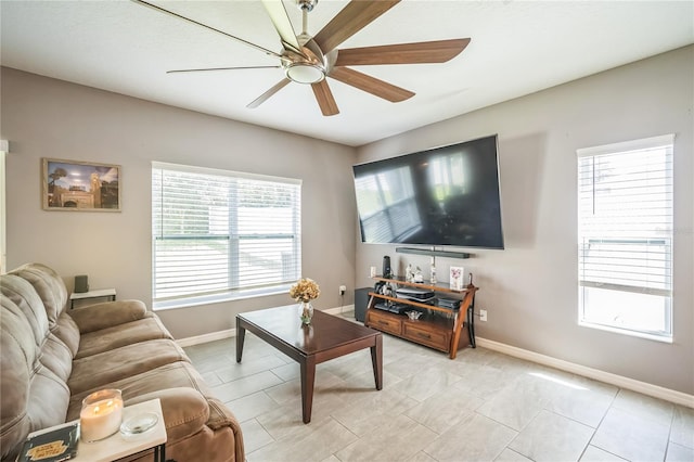 living room with ceiling fan and light tile patterned flooring