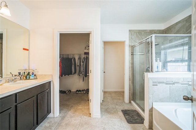 bathroom featuring tile patterned flooring, vanity, and separate shower and tub