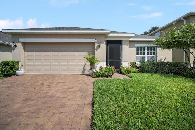 view of front facade with a garage and a front lawn