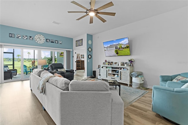 living room with ceiling fan and light wood-type flooring