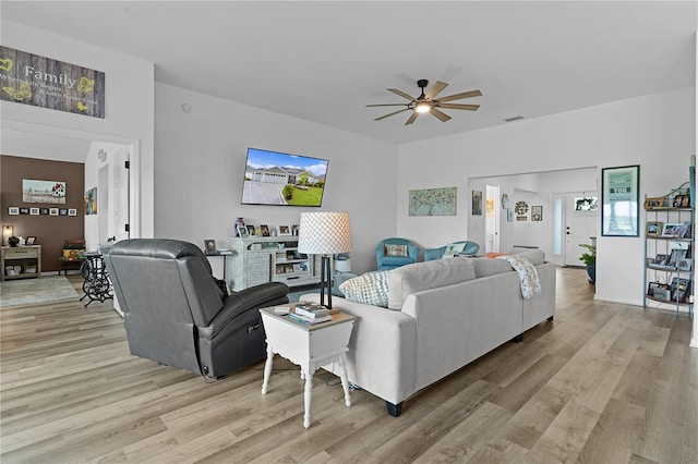 living room with ceiling fan and light wood-type flooring