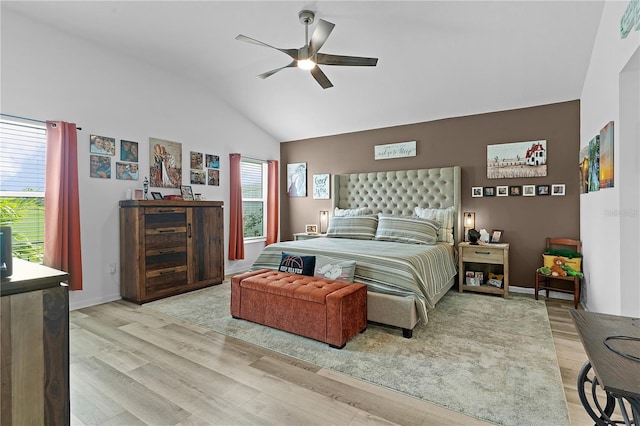 bedroom featuring ceiling fan, light wood-type flooring, and lofted ceiling