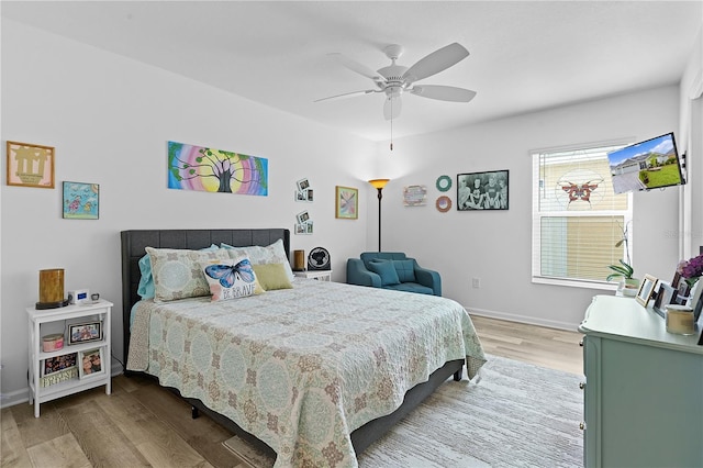 bedroom with ceiling fan and light hardwood / wood-style floors