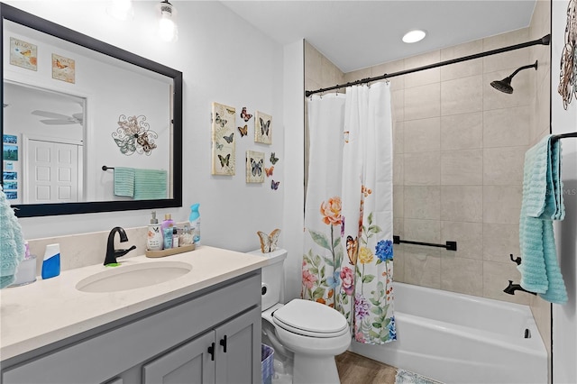 full bathroom featuring toilet, shower / bath combo, hardwood / wood-style flooring, and vanity