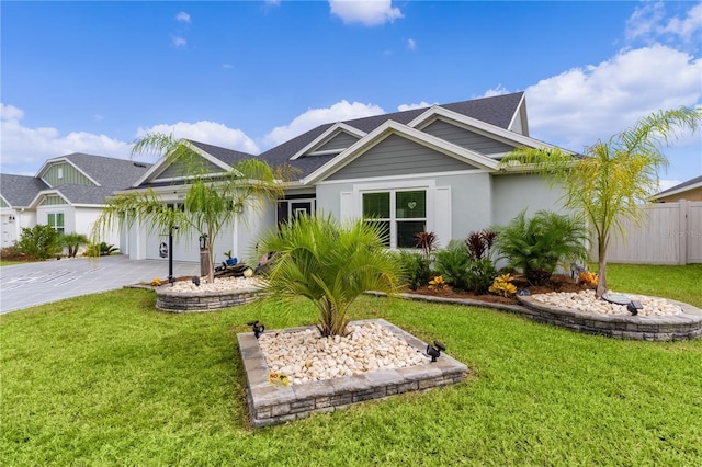 view of front of property featuring a garage and a front lawn