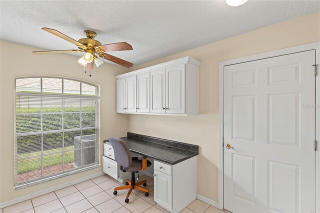 tiled home office featuring a textured ceiling and ceiling fan