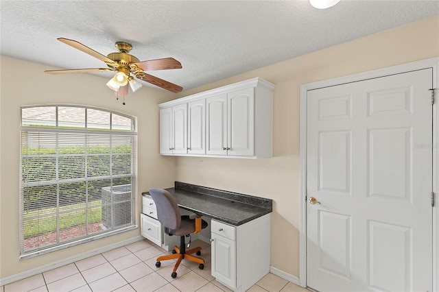 office area with baseboards, a textured ceiling, light tile patterned flooring, and a ceiling fan