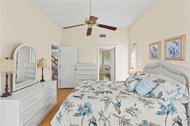 bedroom featuring light wood-type flooring, high vaulted ceiling, and ceiling fan