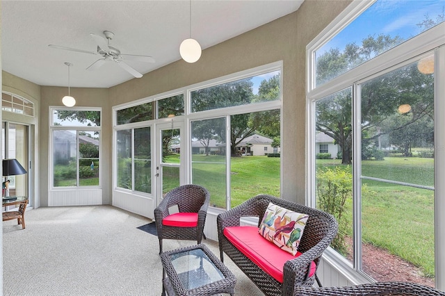 sunroom / solarium with a wealth of natural light and ceiling fan