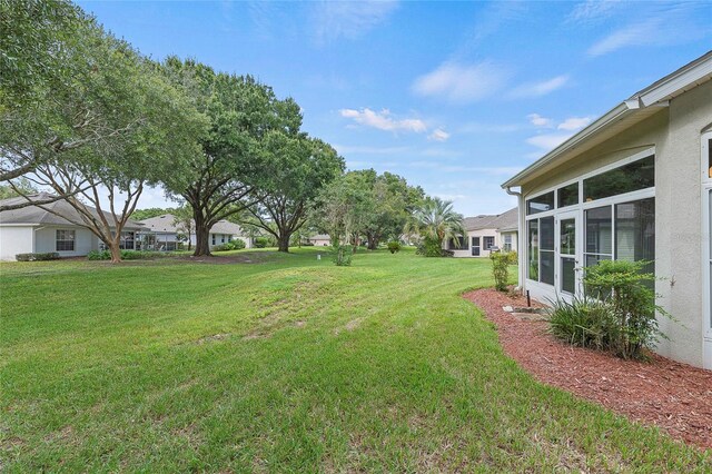 view of yard featuring a sunroom