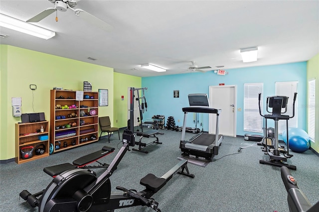 exercise room with baseboards and a ceiling fan