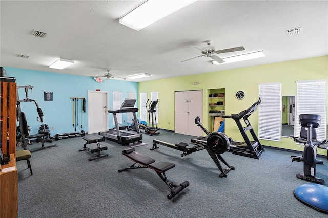 gym with visible vents and ceiling fan