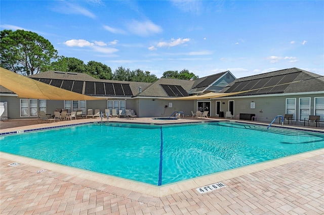 community pool with a patio area