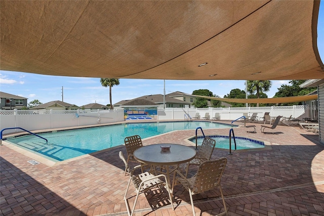 pool with a fenced backyard and a patio