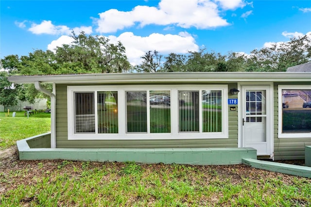 view of property exterior with a lawn