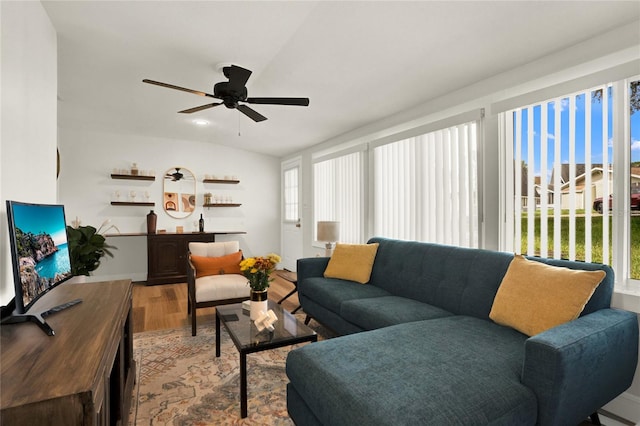 living room with lofted ceiling, a healthy amount of sunlight, light hardwood / wood-style flooring, and ceiling fan