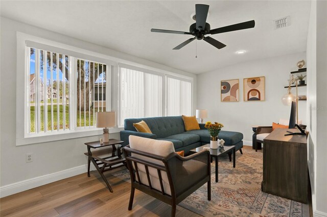 living room with hardwood / wood-style flooring and ceiling fan