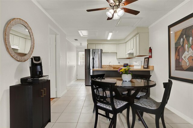 dining area with ceiling fan, sink, and light tile patterned floors