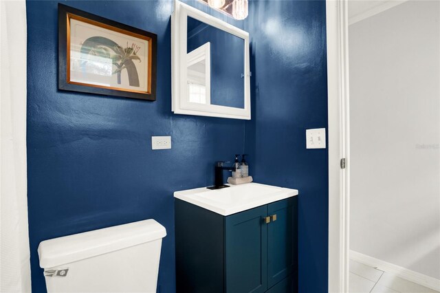 bathroom with tile patterned flooring, vanity, and toilet