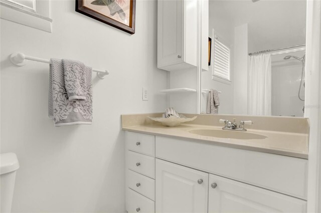 bathroom with vanity, toilet, and a shower with curtain