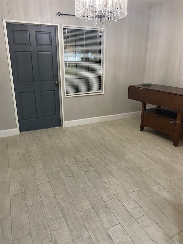 dining space with light hardwood / wood-style flooring and a chandelier