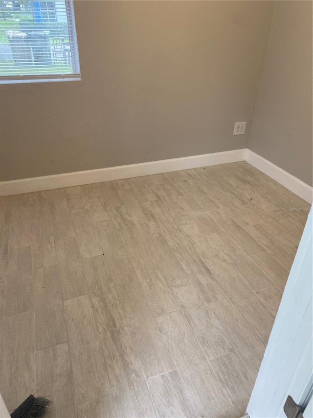 empty room with hardwood / wood-style flooring