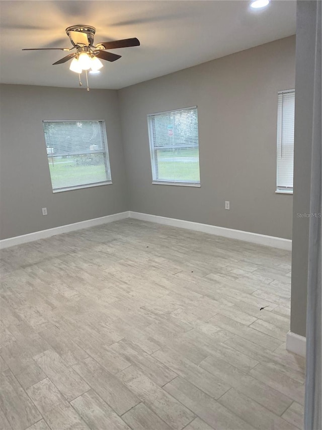 spare room with ceiling fan and light hardwood / wood-style floors