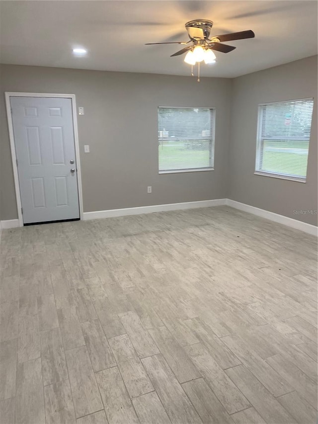 unfurnished room featuring ceiling fan and light hardwood / wood-style floors