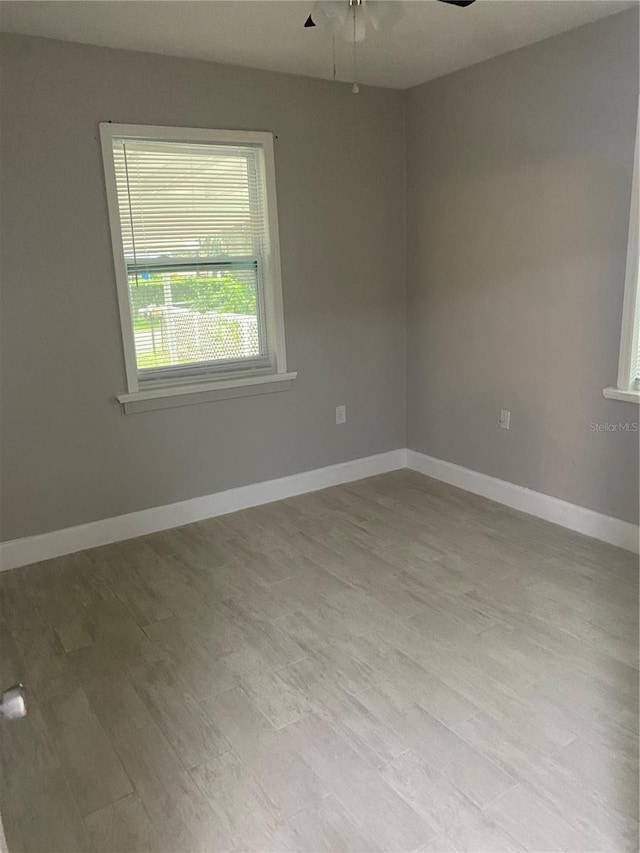 spare room featuring light wood-type flooring and ceiling fan