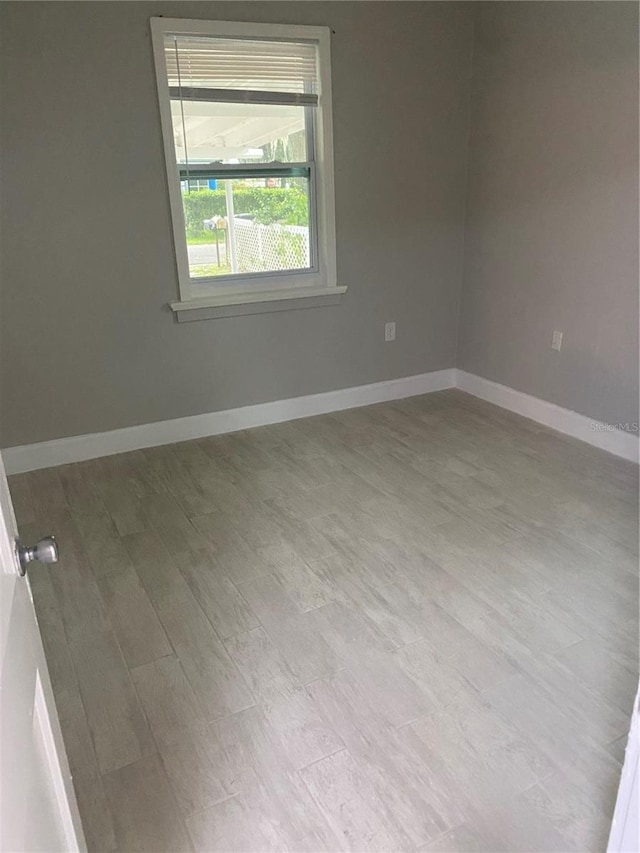 unfurnished room with light hardwood / wood-style flooring