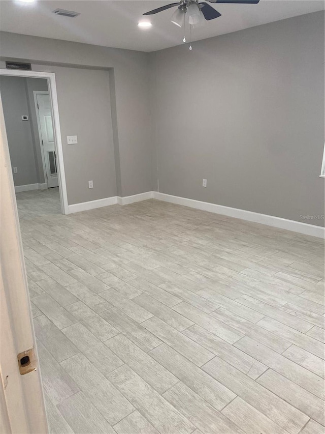 spare room with ceiling fan and light hardwood / wood-style floors