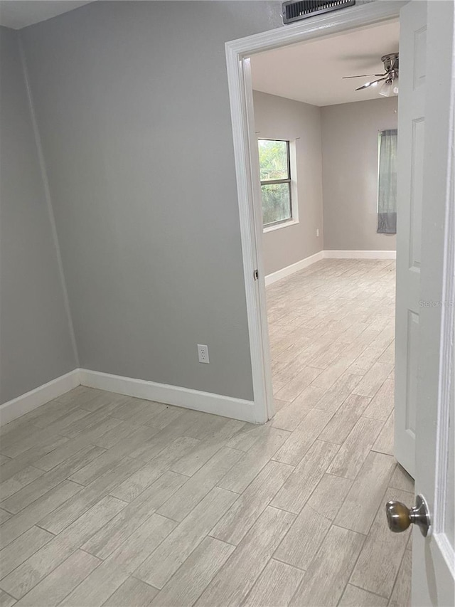 unfurnished room featuring ceiling fan and light hardwood / wood-style floors