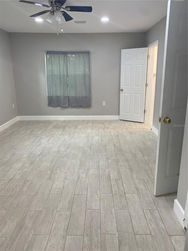 empty room with light hardwood / wood-style flooring and ceiling fan