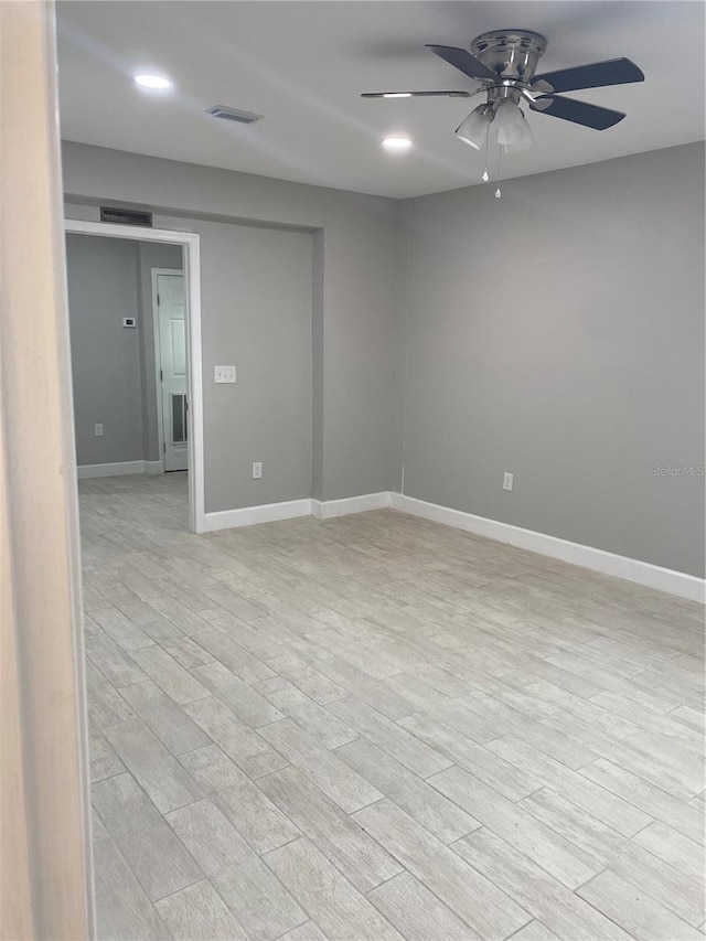 unfurnished room with light wood-type flooring and ceiling fan