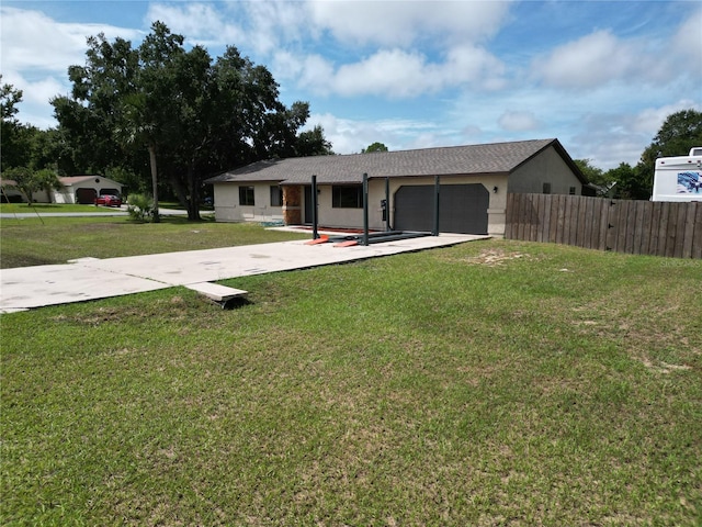 view of front of home with a front yard and a garage