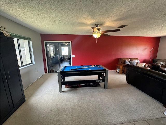 playroom featuring light carpet, pool table, a textured ceiling, and ceiling fan