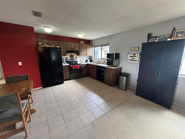 kitchen featuring a textured ceiling, dark brown cabinets, black appliances, light carpet, and sink