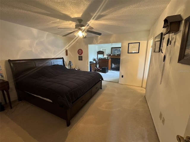 carpeted bedroom featuring a textured ceiling and ceiling fan