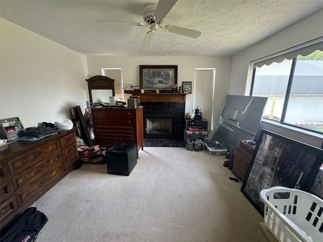 carpeted living room featuring ceiling fan and a textured ceiling