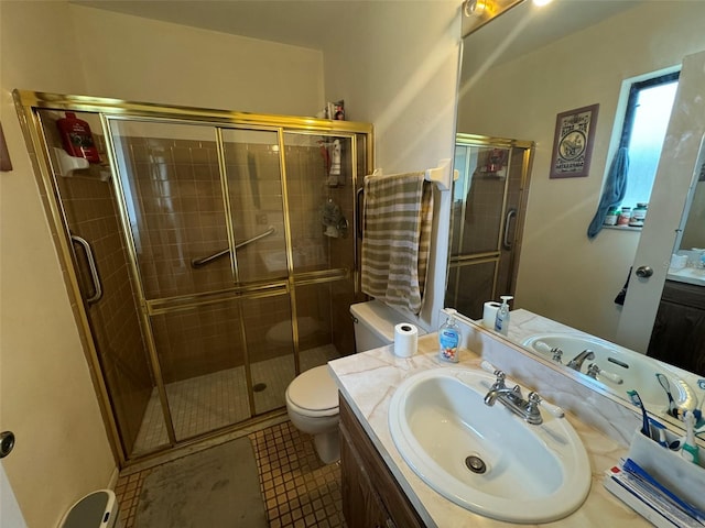 bathroom featuring vanity, toilet, tile patterned flooring, and a shower with door