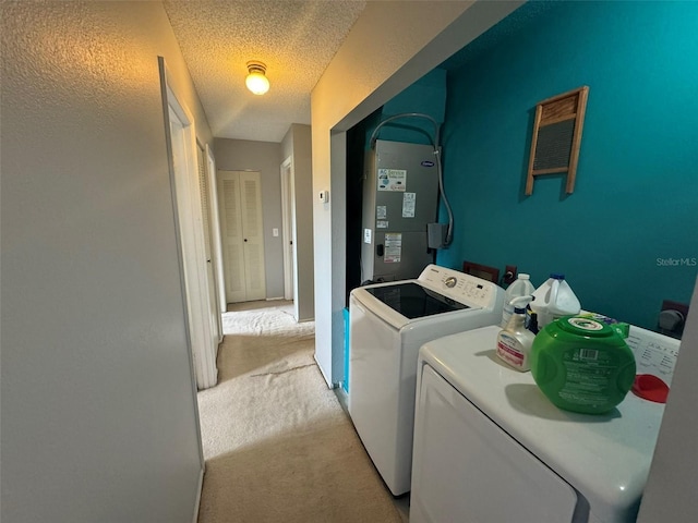 laundry room with a textured ceiling, light colored carpet, separate washer and dryer, and heating unit