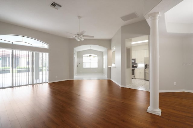 unfurnished living room with vaulted ceiling, light hardwood / wood-style flooring, decorative columns, and ceiling fan