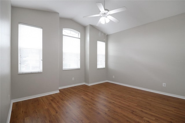 unfurnished room featuring lofted ceiling, ceiling fan, a healthy amount of sunlight, and dark hardwood / wood-style flooring