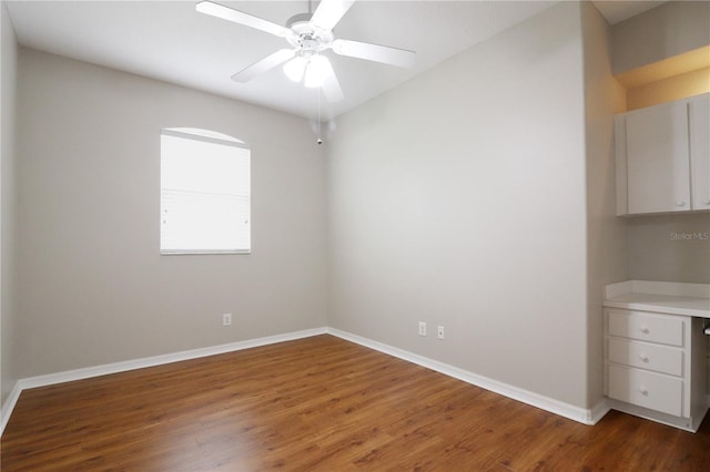 unfurnished room with dark hardwood / wood-style floors and ceiling fan