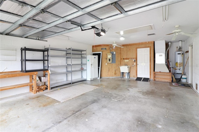 garage with sink, a garage door opener, wooden walls, electric panel, and gas water heater