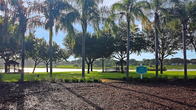 view of community featuring a gazebo, a yard, and a water view